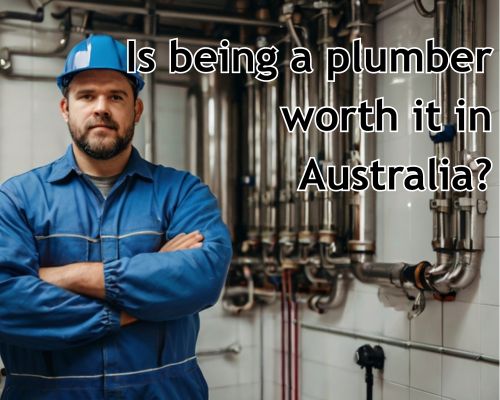 Plumber in blue uniform standing ready.